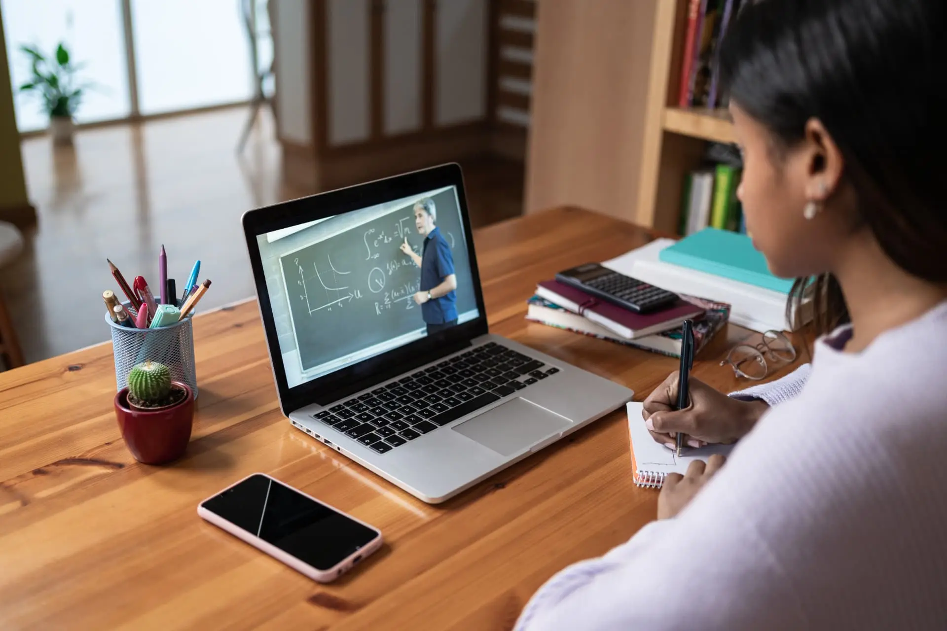 A student attending a virtual university-style class from home