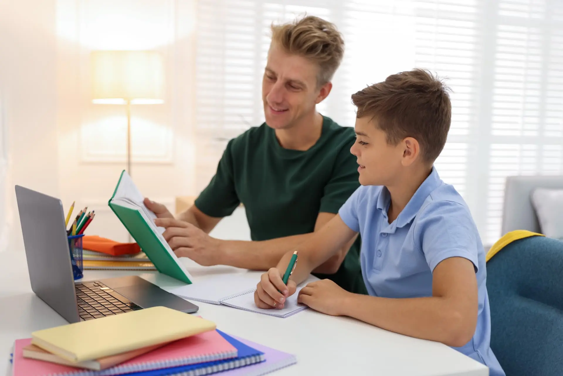 A mentor guiding a student through personalised lessons at a laptop